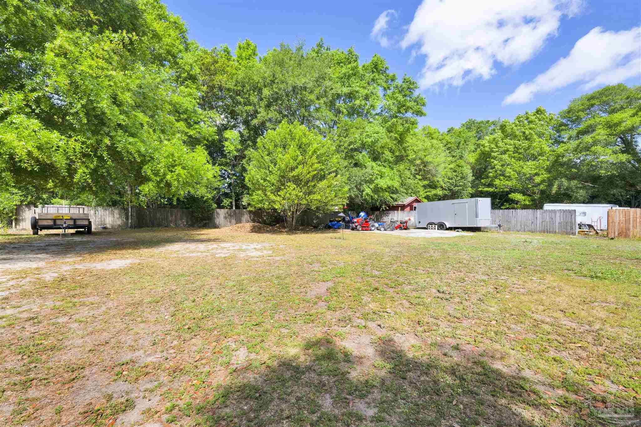 5131 Oakleaf Drive Pace, FL 32571 - Photo 18 of 23 a view of a swimming pool with lawn chairs and plants