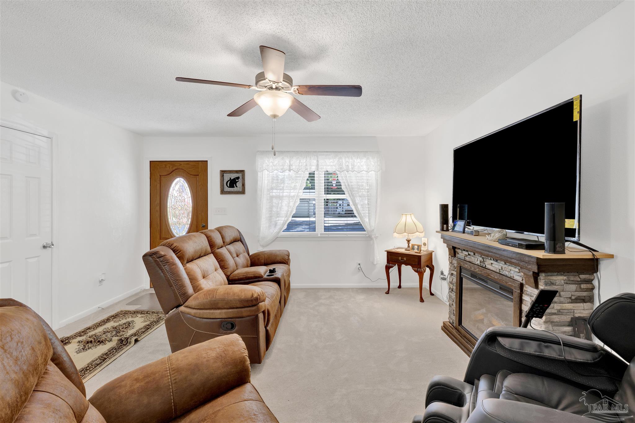 5131 Oakleaf Drive Pace, FL 32571 - Photo 4 of 23 a living room with furniture and a flat screen tv