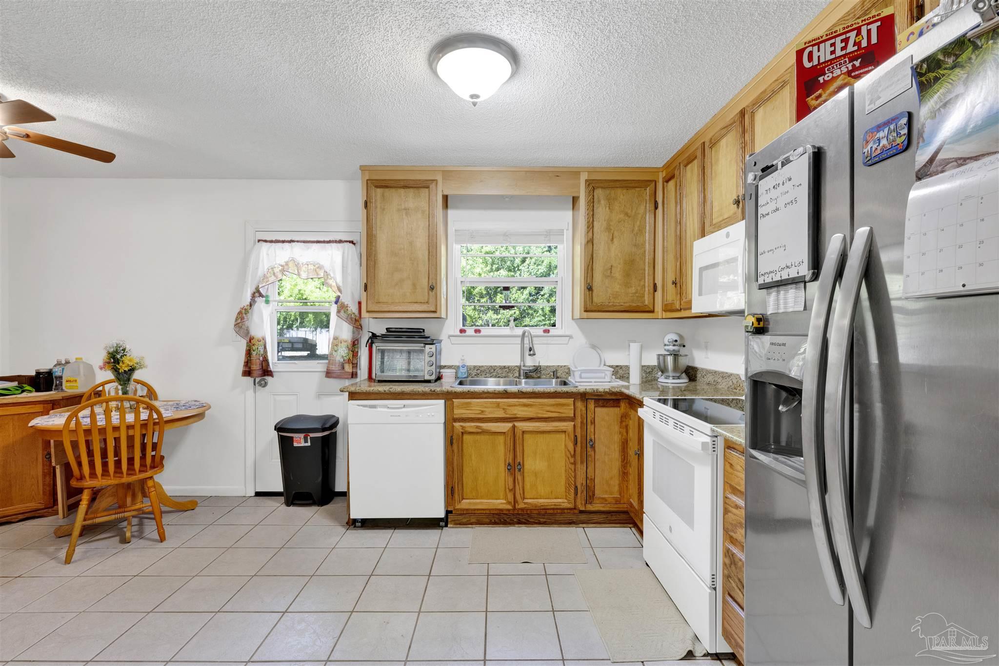 5131 Oakleaf Drive Pace, FL 32571 - Photo 5 of 23 a kitchen with stainless steel appliances granite countertop a refrigerator and a sink