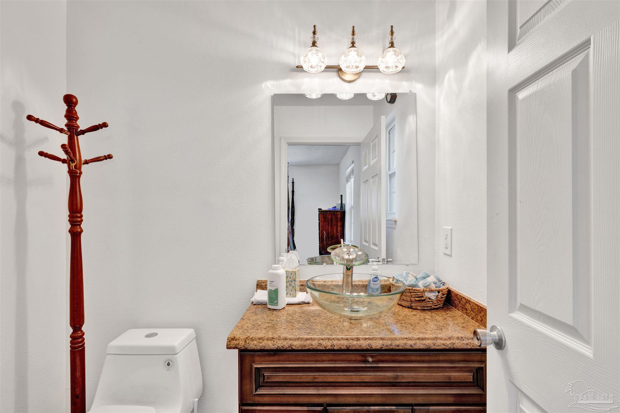 5131 Oakleaf Drive Pace, FL 32571 - Photo 10 of 23 a bathroom with a sink vanity and mirror