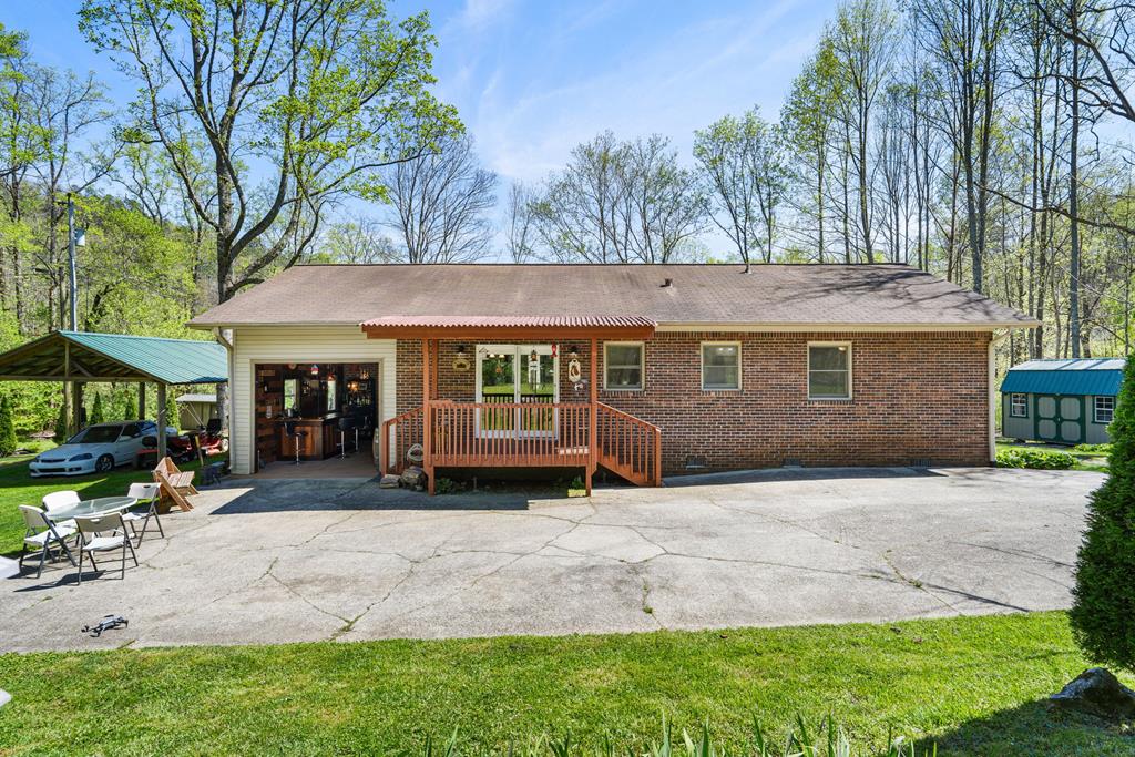496 Jackie Cove Road Hayesville, NC 28904 - Photo 1 of 41 a front view of a house with a garden and trees