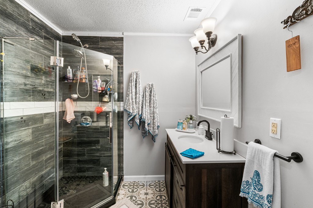 496 Jackie Cove Road Hayesville, NC 28904 - Photo 14 of 41 a bathroom with a sink vanity granite and a mirror