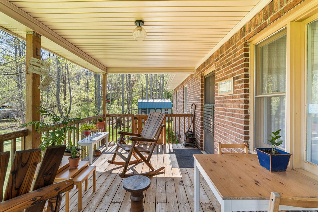 496 Jackie Cove Road Hayesville, NC 28904 - Photo 21 of 41 a balcony view with a dining table and chairs
