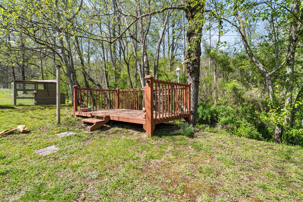 496 Jackie Cove Road Hayesville, NC 28904 - Photo 24 of 41 a view of a backyard with wooden fence and a bench