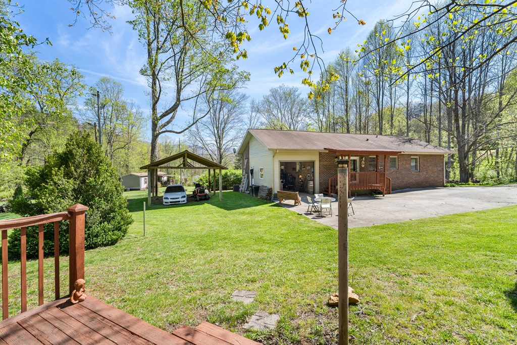 496 Jackie Cove Road Hayesville, NC 28904 - Photo 32 of 41 a view of a house with backyard and tree