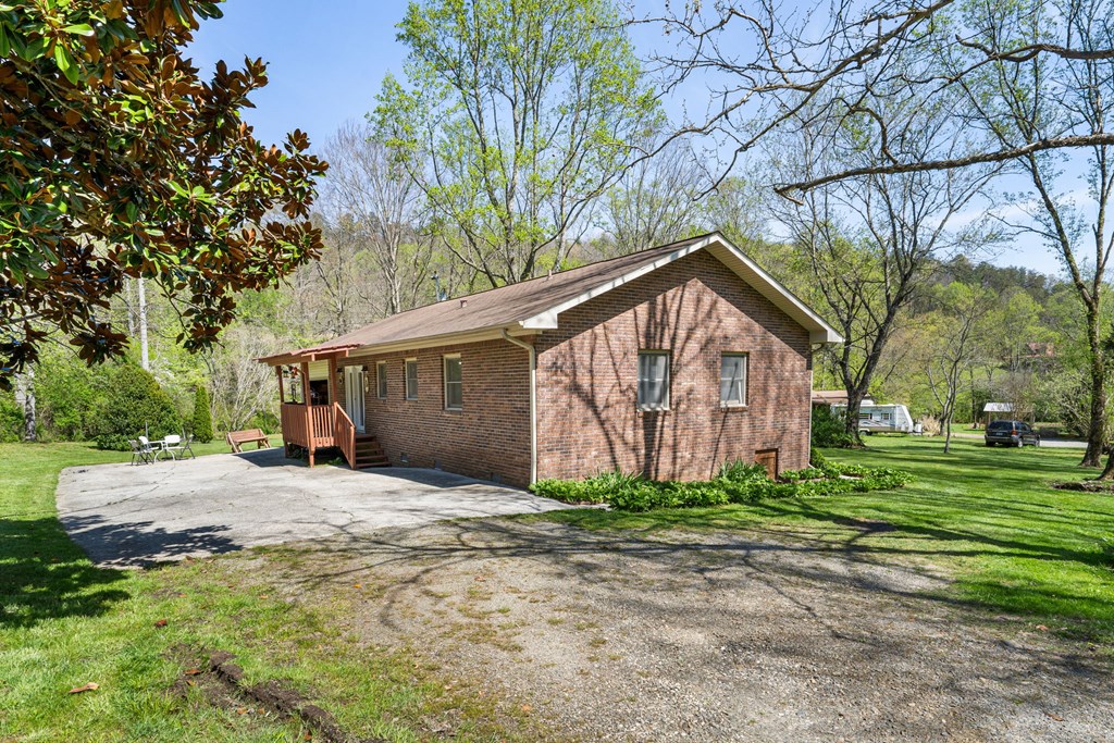 496 Jackie Cove Road Hayesville, NC 28904 - Photo 34 of 41 a view of a house with a yard and large tree
