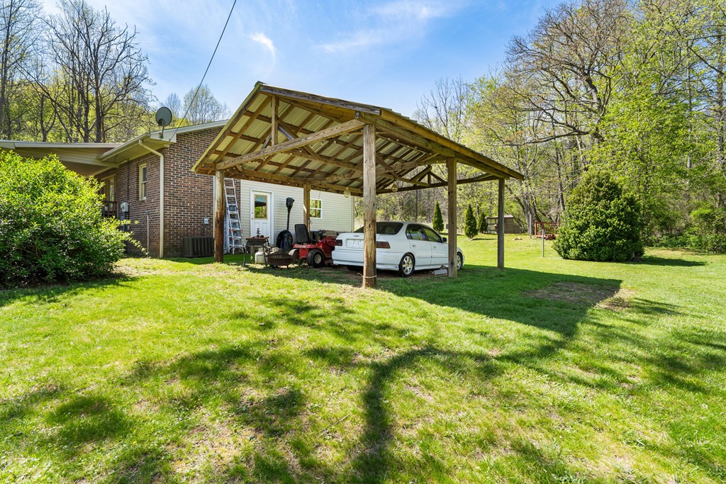 496 Jackie Cove Road Hayesville, NC 28904 - Photo 37 of 41 a view of a big house with a big yard and potted plants