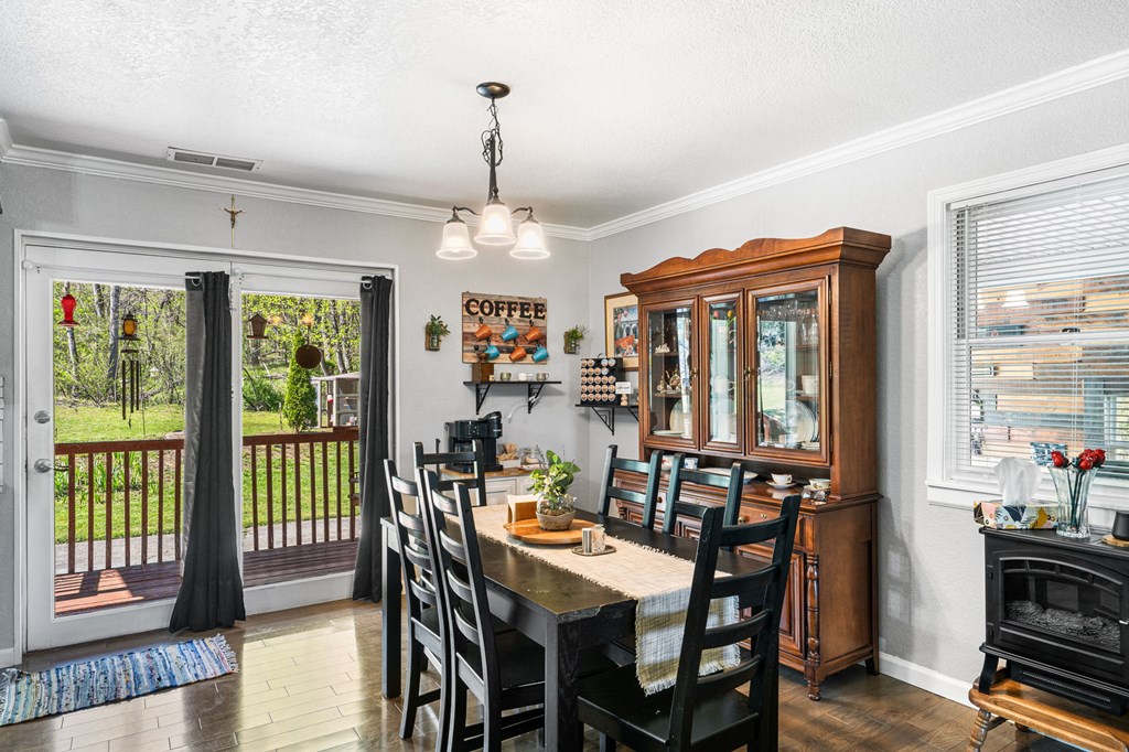 496 Jackie Cove Road Hayesville, NC 28904 - Photo 6 of 41 a view of a dining room with furniture window and wooden floor