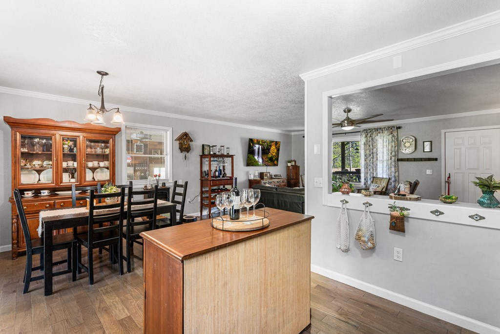496 Jackie Cove Road Hayesville, NC 28904 - Photo 7 of 41 a kitchen with a dining table chairs stove and white cabinets