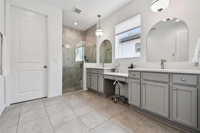 a bathroom with a sink vanity and a mirror