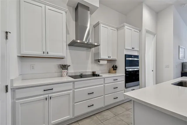 a kitchen with cabinets appliances a sink and dishwasher