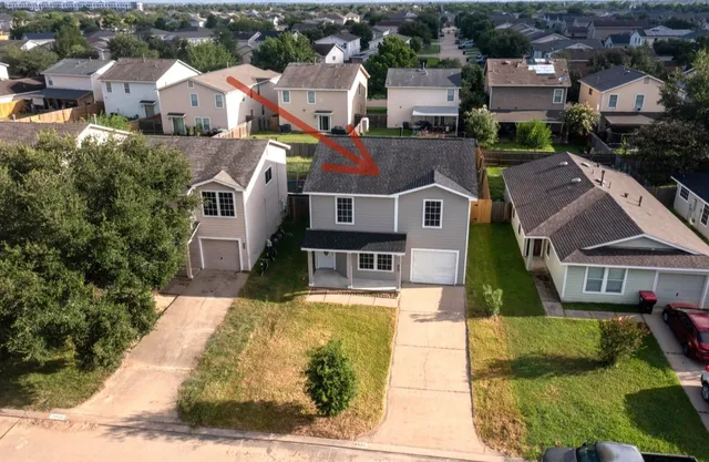 an aerial view of multiple houses with yard