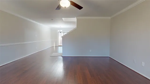 a view of a room with wooden floors and white walls
