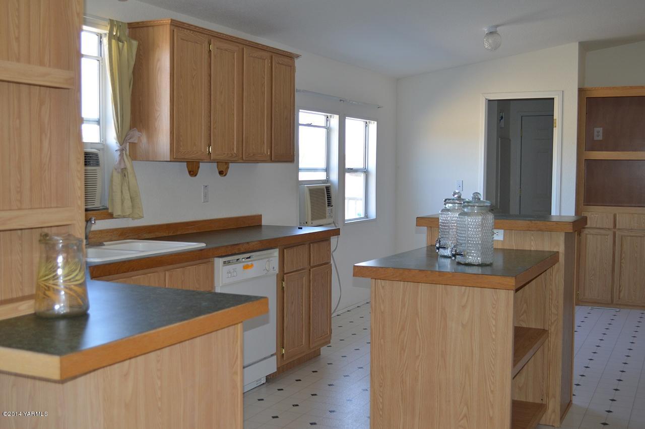 205 Mini Pines Road Yakima, WA 98903 - Photo 2 of 23 a kitchen with stainless steel appliances granite countertop a sink stove and cabinets