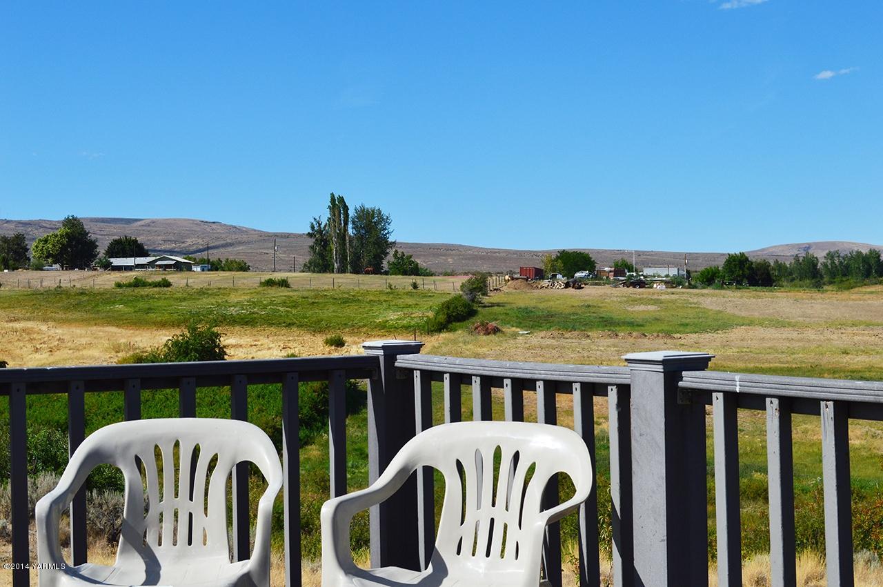 205 Mini Pines Road Yakima, WA 98903 - Photo 5 of 23 a view of a house with lawn chairs and a table
