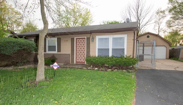 a front view of house with a garden