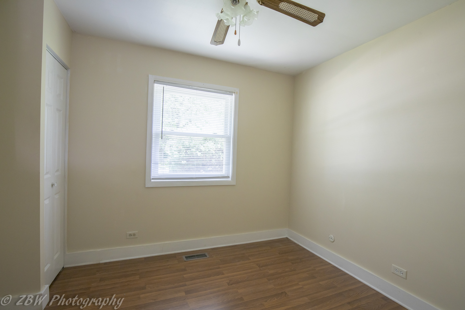129 South Orchard Drive, Unit 1 Bolingbrook, IL 60440 - Photo 12 of 14 an empty room with wooden floor and windows
