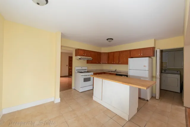 a kitchen with stainless steel appliances a refrigerator and a stove