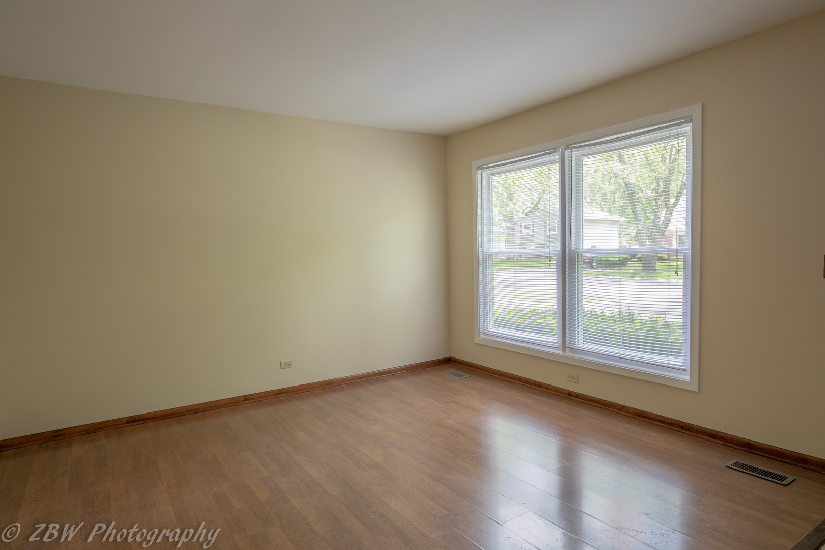 129 South Orchard Drive, Unit 1 Bolingbrook, IL 60440 - Photo 8 of 14 an empty room with wooden floor and windows