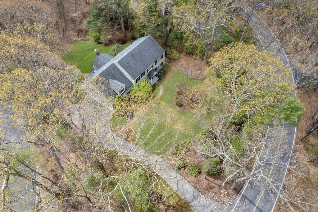47 Claypit Hill Road Wayland, MA 01778 - Photo 21 of 21 a backyard of a house with a yard and outdoor seating