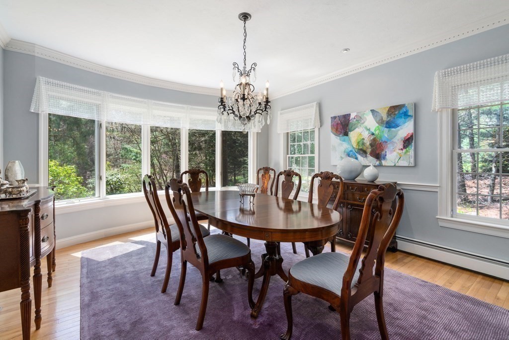 47 Claypit Hill Road Wayland, MA 01778 - Photo 9 of 21 a dining room with furniture a large window and a chandelier