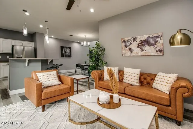 a living room with furniture and a wooden floor