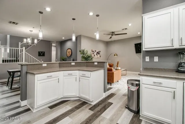 a kitchen with a sink stainless steel appliances and cabinets
