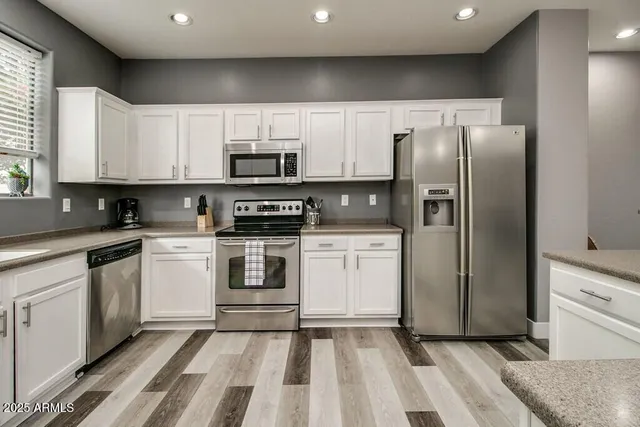 a kitchen with a refrigerator stove and sink
