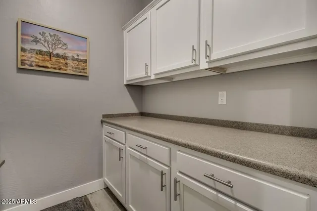 a utility room with cabinets