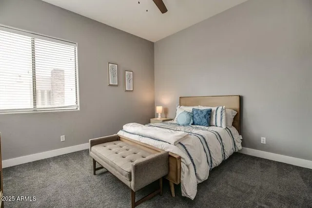 a bed sitting in a bedroom next to a window