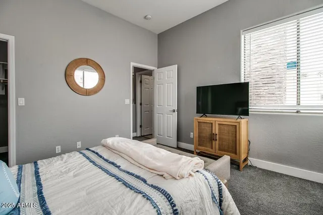 a bedroom with a bed and a flat screen tv