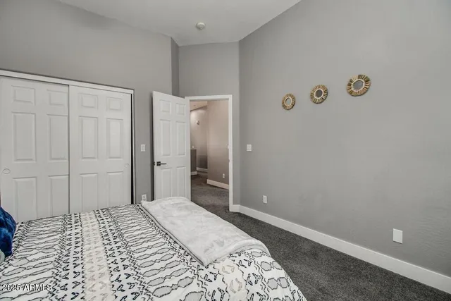 a bedroom with a bed and a lamp