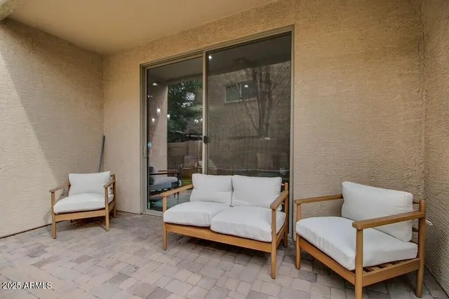 a living room with furniture and a potted plant