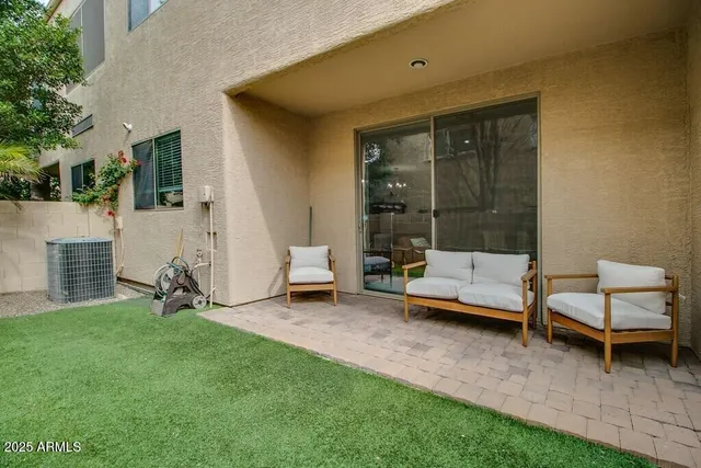 a view of a house with a backyard and a patio