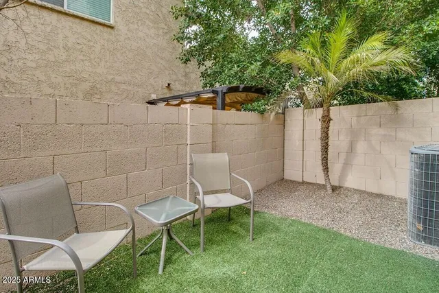 a view of a chairs and table in backyard