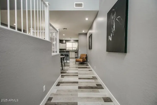 a view of entryway and hall with wooden floor