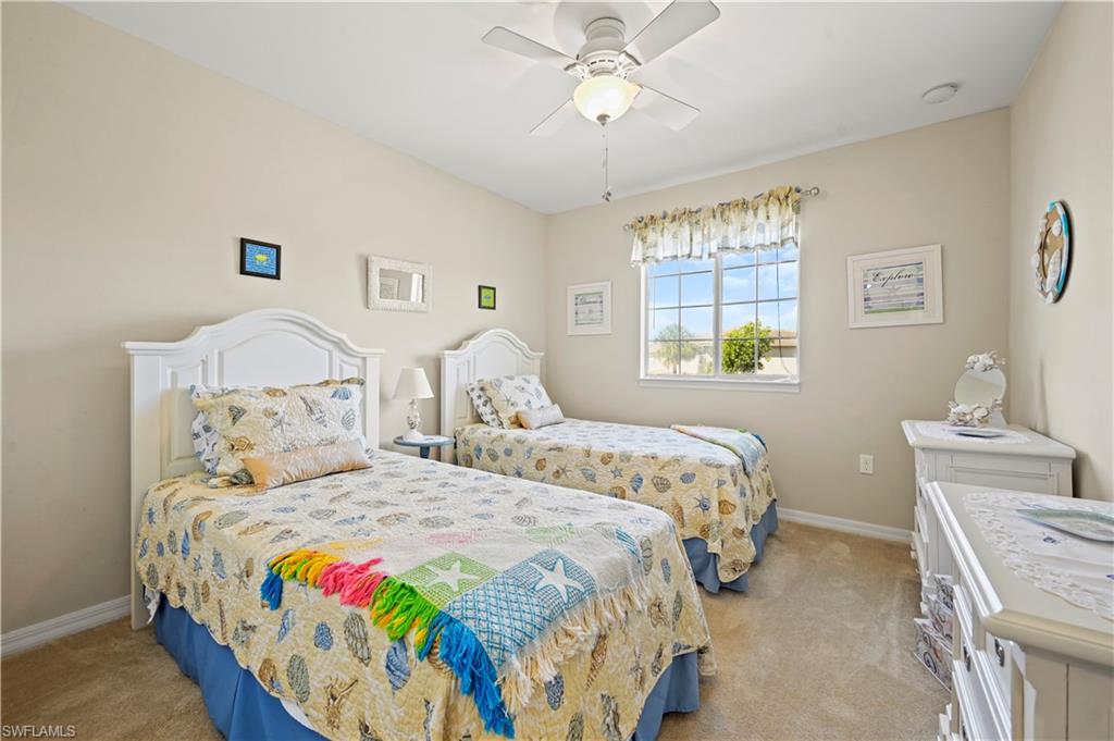 3922 Cherrybrook Loop Fort Myers, FL 33966 - Photo 11 of 38 a bedroom with two beds and a window