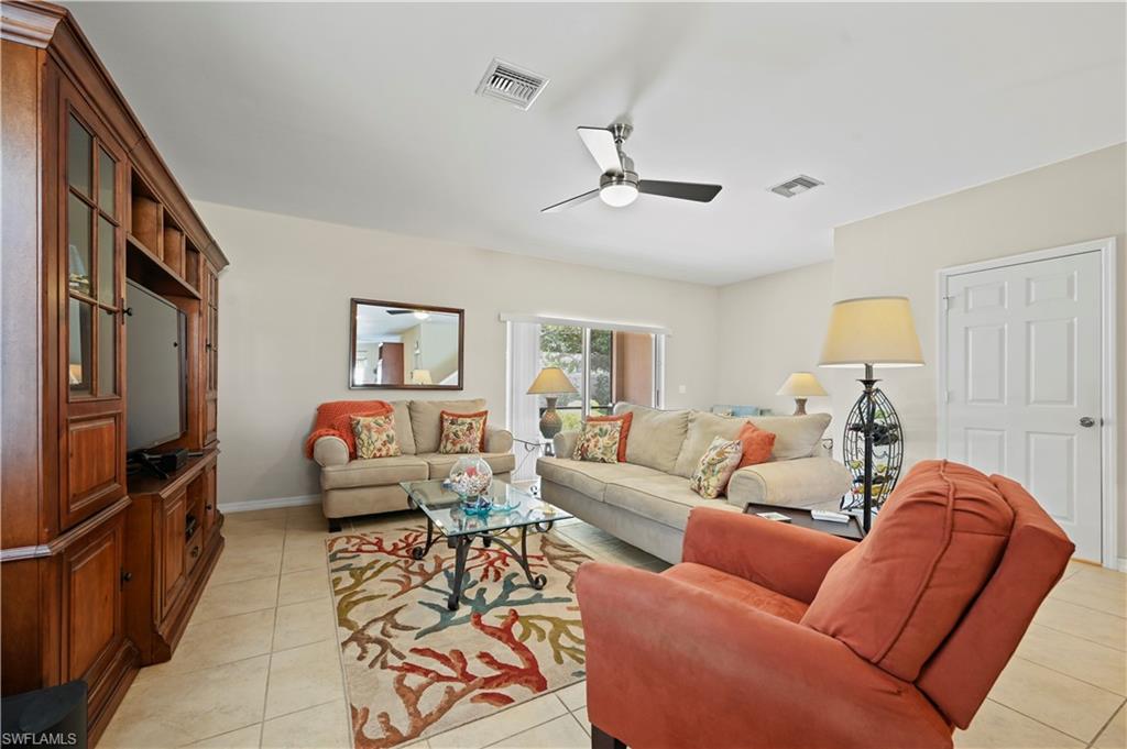 3922 Cherrybrook Loop Fort Myers, FL 33966 - Photo 4 of 38 a living room with furniture ceiling fan and a rug