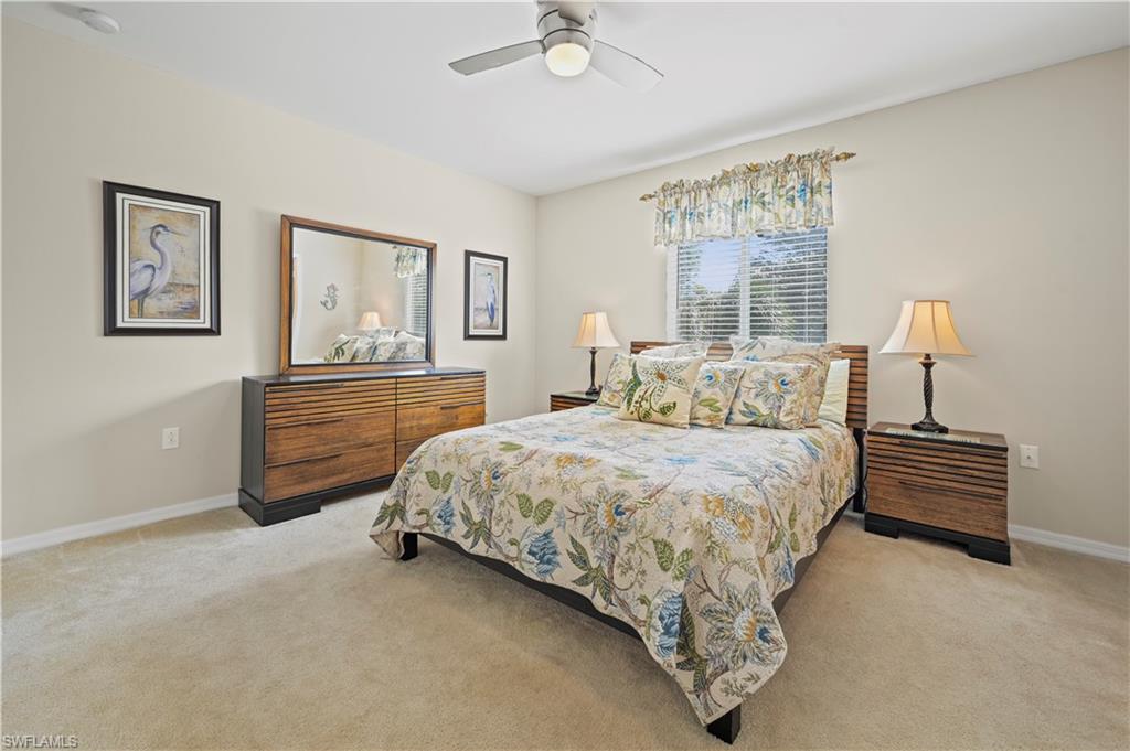 3922 Cherrybrook Loop Fort Myers, FL 33966 - Photo 10 of 38 a spacious bedroom with a bed and a chandelier