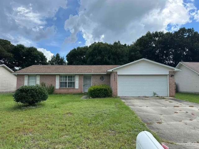 a backyard of a house with plants and garden
