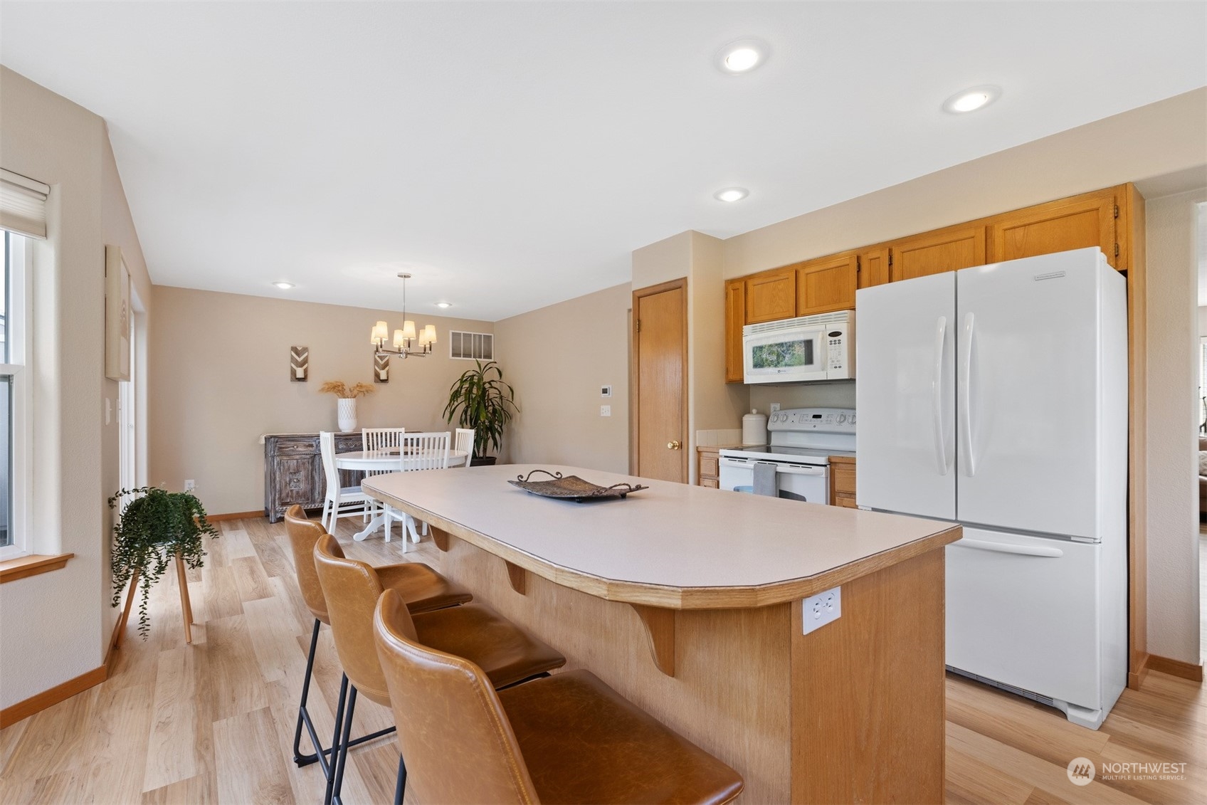 1308 Roma Road Bellingham, WA 98226 - Photo 10 of 39 a kitchen with stainless steel appliances refrigerator dining table and chairs