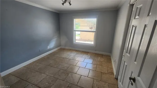 a view of an empty room and a window