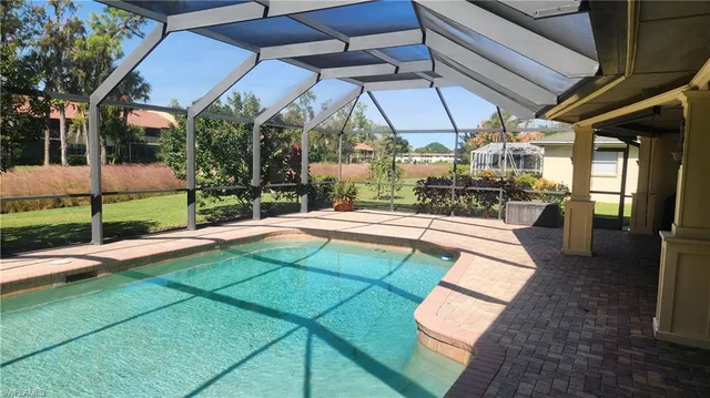 a view of a patio with table and chairs under an umbrella