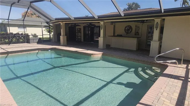 a view of a patio with a table and chairs under an umbrella