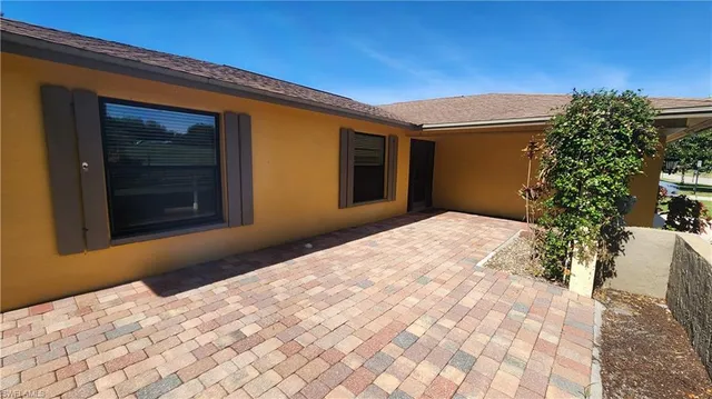 a bedroom with a bed and a potted plant