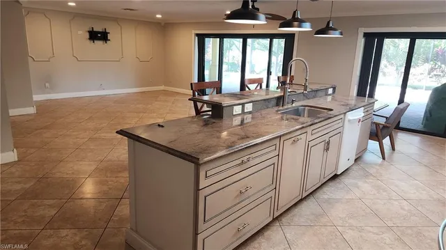 a kitchen with stainless steel appliances granite countertop a sink and a counter space