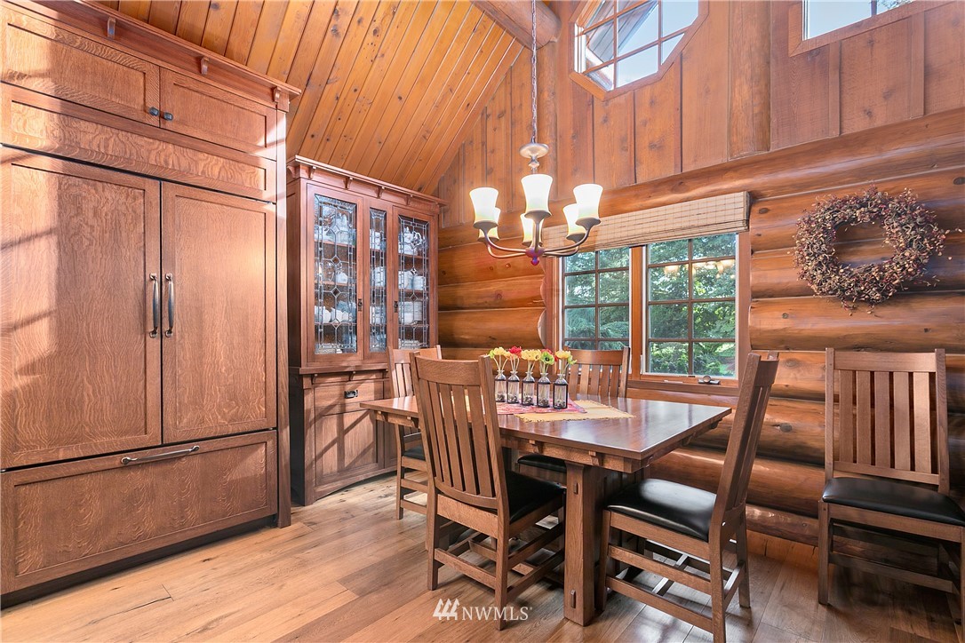 698 West Pole Road Ferndale, WA 98248 - Photo 21 of 40 a dining room with furniture a chandelier and wooden floor