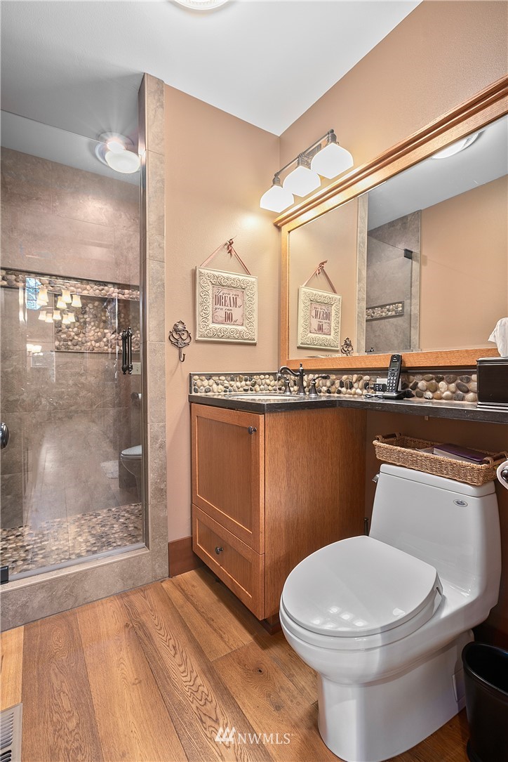 698 West Pole Road Ferndale, WA 98248 - Photo 26 of 40 a bathroom with a toilet a sink and mirror