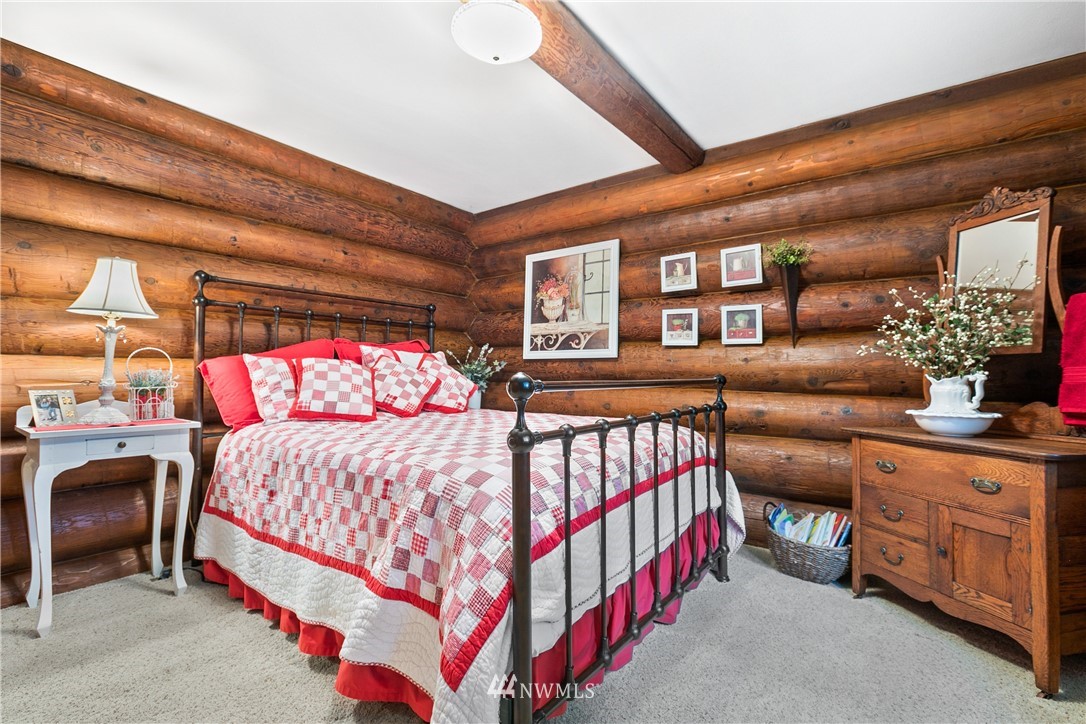 698 West Pole Road Ferndale, WA 98248 - Photo 32 of 40 a bedroom with a bed and a chandelier