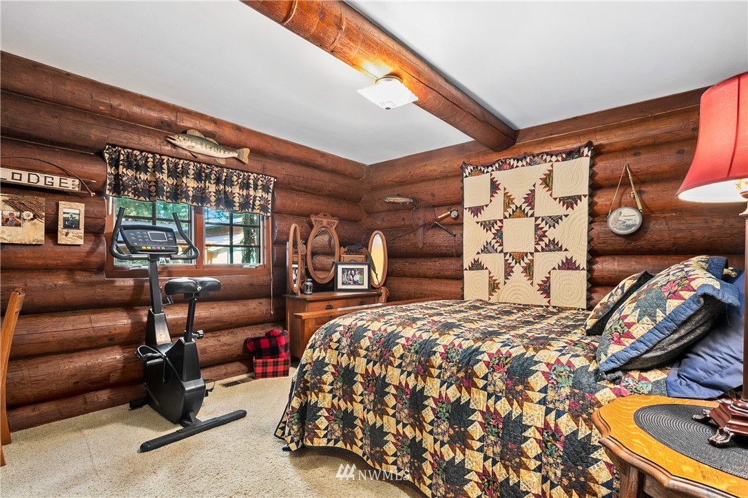 698 West Pole Road Ferndale, WA 98248 - Photo 33 of 40 a bed sitting in a bedroom next to a window and a lamp